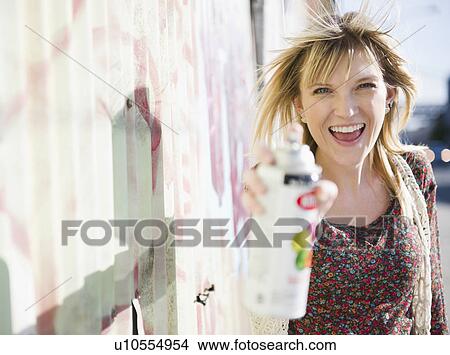 USA, Brooklyn, Williamsburg, Woman spraying with paint can View Large Photo Image Picture - USA, Brooklyn, Williamsburg, Woman spraying with paint can. Fotosearch