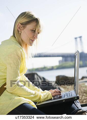USA, Brooklyn, Williamsburg, Woman using laptop View Large Photo Image Picture - USA, Brooklyn, Williamsburg, Woman using laptop. Fotosearch