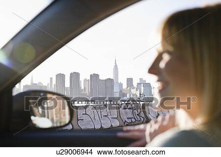 USA, Brooklyn, Williamsburg, Woman driving through city View Large Photo Image Picture - USA, Brooklyn, Williamsburg, Woman driving through city. Fotosearch