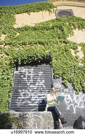 USA, Brooklyn, Williamsburg, Woman reading outside View Large Photo Image Stock Image - USA, Brooklyn, Williamsburg, Woman reading outside. Fotosearch