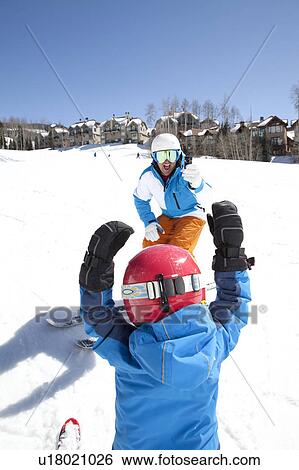 Stock Photograph - USA, Colorado, Telluride, Father skiing with son (2-3). Fotosearch