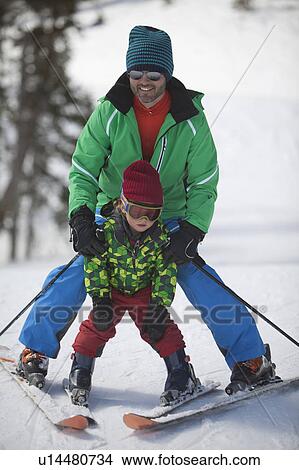 USA, Colorado, Telluride, Father with son (4-5) skiing together View Large Photo Image Picture - USA, Colorado, Telluride, Father with son (4-5) skiing together. Fotosearch