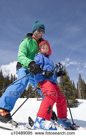 USA, Colorado, Telluride, Father with son (8-9) skiing together View Large Photo Image Stock Photography - USA, Colorado, Telluride, Father with son (8-9) skiing together. Fotosearch