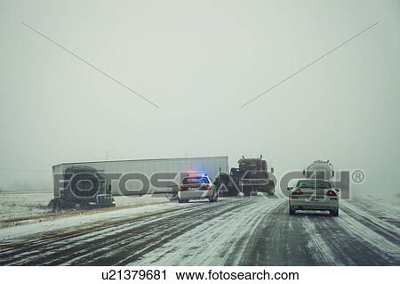Stock Image - USA, Illinois, Springfield, Semi truck accident on highway during storm. Fotosearch