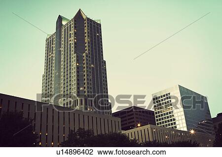 Stock Image - USA, Missouri, St. Louis, Buildings at dusk. Fotosearch