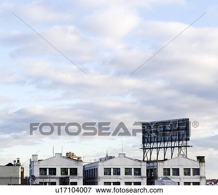 Stock Photo - USA, New York, Brooklyn, Williamsburg, Houses against cloudy sky. Fotosearch