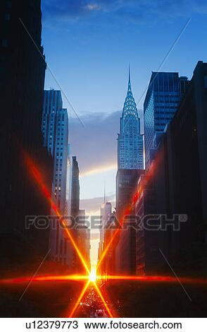 Stock Image - USA, New York, New York City, Chrysler Building and street at sunset. Fotosearch