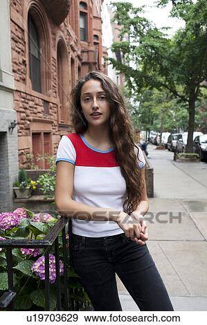 USA, New York, New York City, Portrait of young woman standing on street View Large Photo Image Stock Photo - USA, New York, New York City, Portrait of young woman standing on street. Fotosearch
