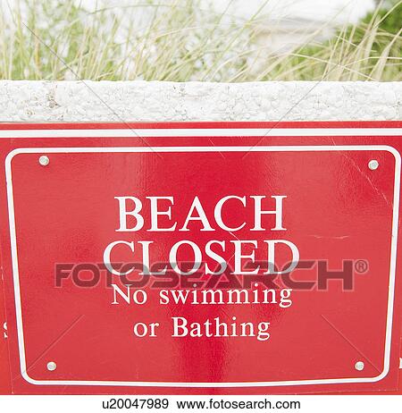 Stock Photo - USA, New York, Queens, Rockaway Beach, close up of warning sign about closed beach. Fotosearch