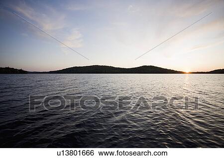Stock Photograph - USA, New York State, Adirondack Mountains, Lake Placid at sunset. Fotosearch