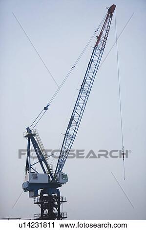 Stock Image - USA, New York State, New York City, Cranes against sky. Fotosearch
