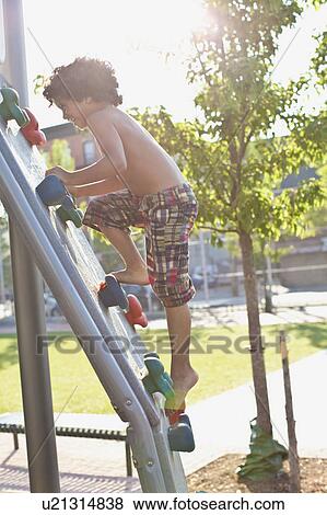 USA, New York State, New York City, Brooklyn, Boy (6-7) climbing up jungle gym View Large Photo Image Stock Photo - USA, New York State, New York City, Brooklyn, Boy (6-7) climbing up jungle gym. Fotosearch
