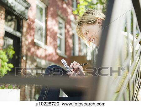USA, New York, Williamsburg, Brooklyn, Smiling woman writing diary View Large Photo Image Stock Image - USA, New York, Williamsburg, Brooklyn, Smiling woman writing diary. Fotosearch