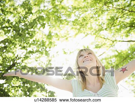 USA, New York, Williamsburg, Brooklyn, Portrait of smiling woman under green tree View Large Photo Image Stock Photography - USA, New York, Williamsburg, Brooklyn, Portrait of smiling woman under green tree. Fotosearch