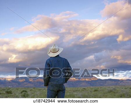 Picture - USA, Utah, Rear view of man standing in desert landscape. Fotosearch