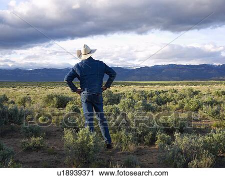 USA, Utah, Rear view of man standing in desert landscape View Large Photo Image Stock Image - USA, Utah, Rear view of man standing in desert landscape. Fotosearch