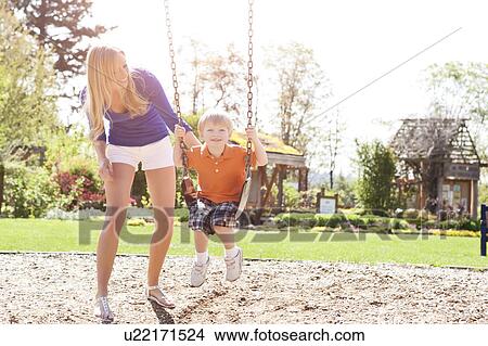 USA, Washington State, Seattle, Mother and son (2-3) swinging on swing in park View Large Photo Image Picture - USA, Washington State, Seattle, Mother and son (2-3) swinging on swing in park. Fotosearch