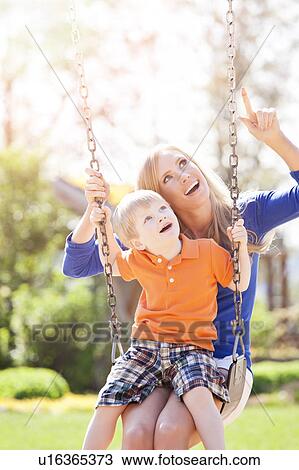 USA, Washington State, Seattle, Mother and son (2-3) swinging on swing in park View Large Photo Image Stock Image - USA, Washington State, Seattle, Mother and son (2-3) swinging on swing in park. Fotosearch