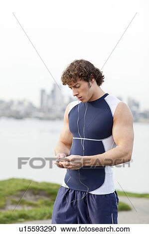 Stock Image - USA, Washington State, Seattle, Young athlete doing workout. Fotosearch