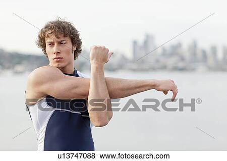 USA, Washington State, Seattle, Young athlete doing workout View Large Photo Image Stock Photo - USA, Washington State, Seattle, Young athlete doing workout. Fotosearch