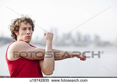 Stock Photography - USA, Washington State, Seattle, Young athlete doing workout. Fotosearch
