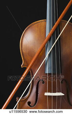 Violin bow over strings View Large Photo Image Stock Image - Violin bow over strings. Fotosearch
