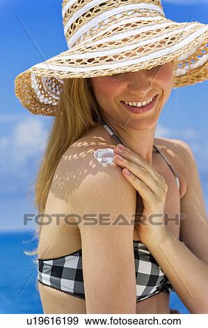 Woman applying sunscreen View Large Photo Image Stock Photo - Woman applying sunscreen. Fotosearch
