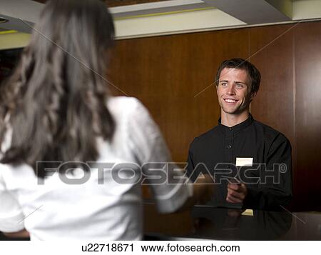 Woman checking in or out of hotel View Large Photo Image Stock Image - Woman checking in or out of hotel. Fotosearch