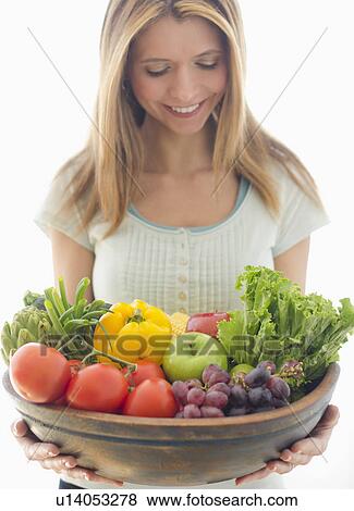 Woman holding bowl of organic fruit and vegetables View Large Photo Image Stock Photo - Woman holding bowl of organic fruit and vegetables. Fotosearch