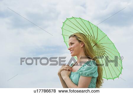 Woman holding parasol View Large Photo Image Stock Photo - Woman holding parasol. Fotosearch