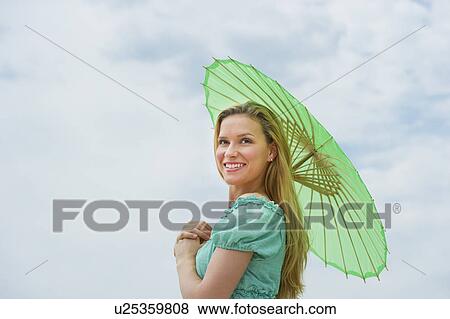 Stock Photo - Woman holding parasol. Fotosearch