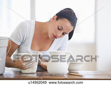 Stock Photo - Woman making pottery. Fotosearch