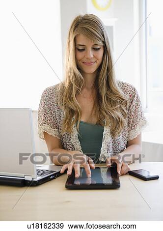 Woman reading e-book View Large Photo Image Stock Photo - Woman reading e-book. Fotosearch