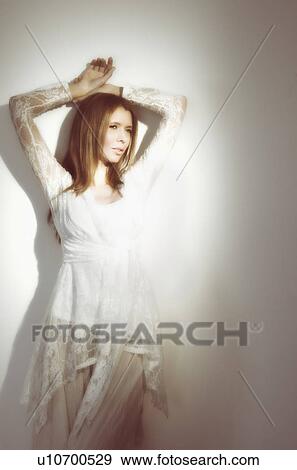 Woman relaxing against wall View Large Photo Image Stock Photo - Woman relaxing against wall. Fotosearch