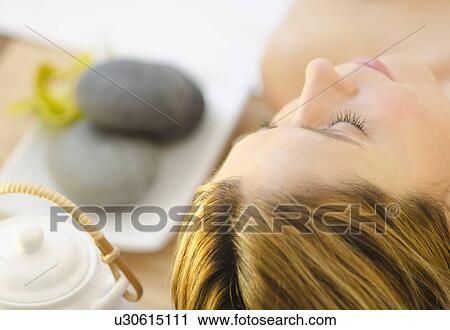 Stock Image -  Woman relaxing at health spa. Fotosearch