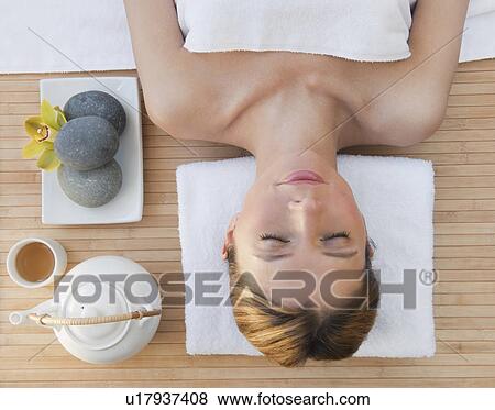 Stock Photo -  Woman relaxing at health spa. Fotosearch