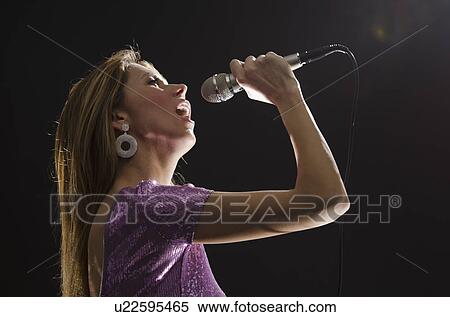 Woman singing in spotlight View Large Photo Image Stock Photography - Woman singing in spotlight. Fotosearch