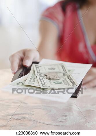 Stock Image - Woman taking money. Fotosearch