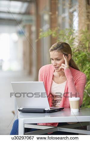 Woman using laptop in cafe View Large Photo Image Stock Photo - Woman using laptop in cafe. Fotosearch