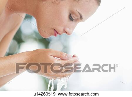 Stock Photo - Woman washing face. Fotosearch