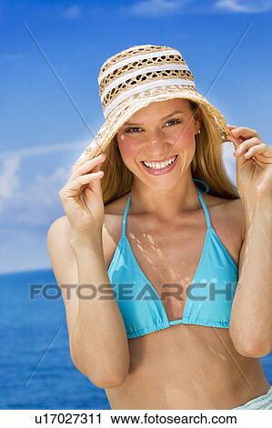 Stock Image - Woman wearing bikini by sea. Fotosearch