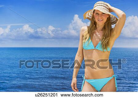Woman wearing bikini by sea View Large Photo Image Stock Image - Woman wearing bikini by sea. Fotosearch