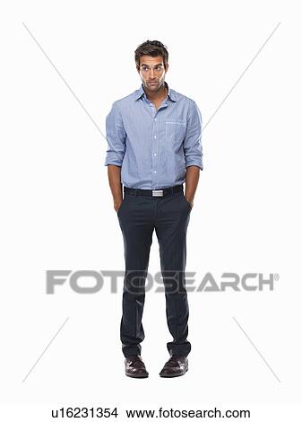Picture - Worried executive standing with hands in pockets against white background. Fotosearch
