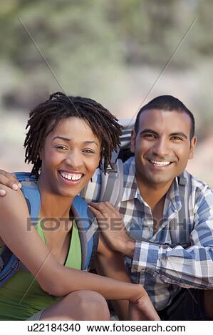 Stock Image - Young couple hiking and enjoying desert scenery. Fotosearch