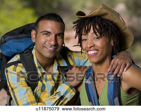 Stock Photo - Young couple hiking and enjoying desert scenery. Fotosearch