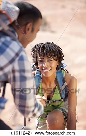 Stock Photo - Young couple hiking and enjoying desert scenery. Fotosearch