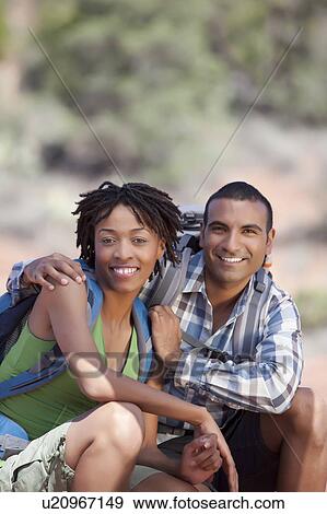Stock Photo - Young couple hiking and enjoying desert scenery. Fotosearch