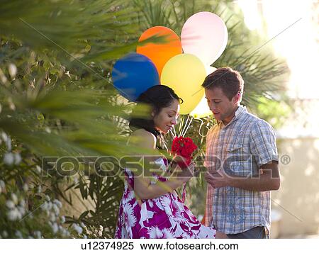 Young couple with balloons and flowers View Large Photo Image Stock Photography - Young couple with balloons and flowers. Fotosearch