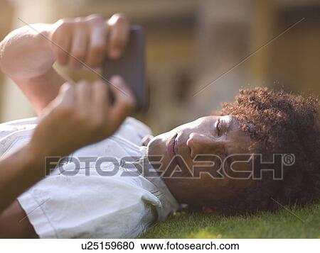 Young man using mobile phone View Large Photo Image Stock Image - Young man using mobile phone . Fotosearch