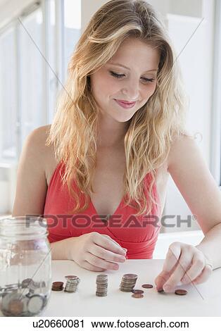 Young woman counting coins View Large Photo Image Stock Image - Young woman counting coins. Fotosearch